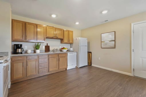 A kitchen with wooden cabinets and white appliances.