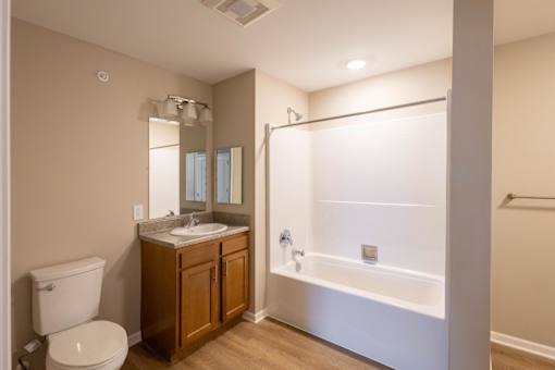 A bathroom with a toilet, sink, and bathtub.