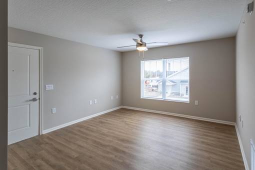 A room with a ceiling fan and a window.