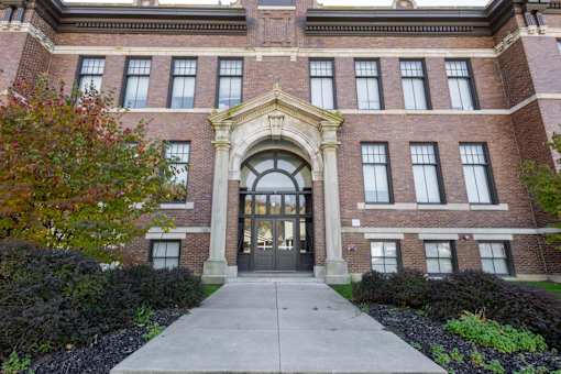 A large brick building with a central arched entrance.
