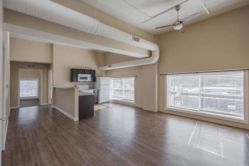 A spacious room with a reception desk and a large window with blinds.