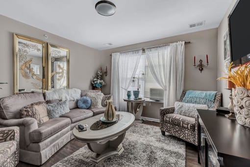 a living room with two couches and two chairs