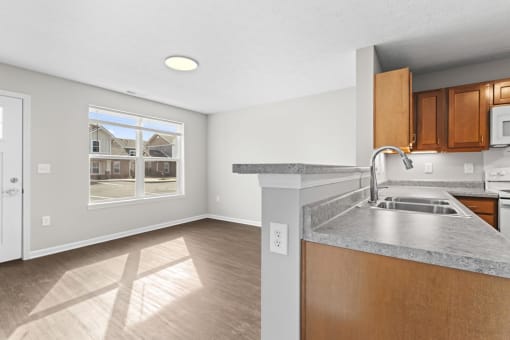 an empty kitchen with a sink and a window