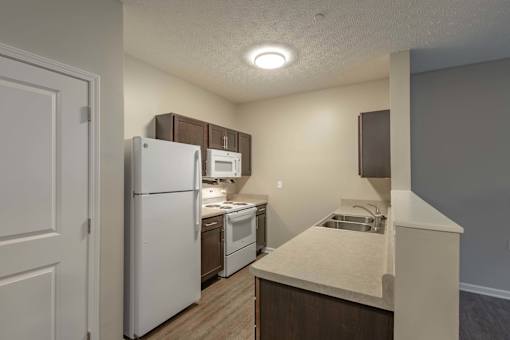 A kitchen with white appliances and a white refrigerator.
