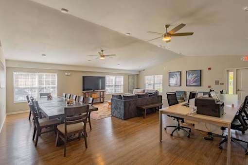A room with a dining table and a work desk.
