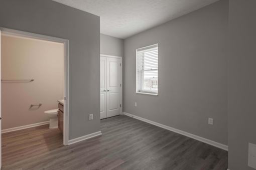 A room with a wooden floor and a white door.