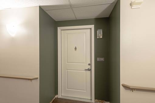 A white door with a number 105 on the wall above it.