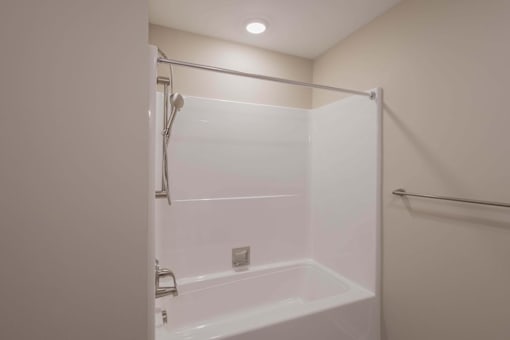 A white bathroom with a glass shower door.