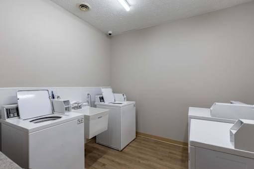 A room with white appliances and a white wall.