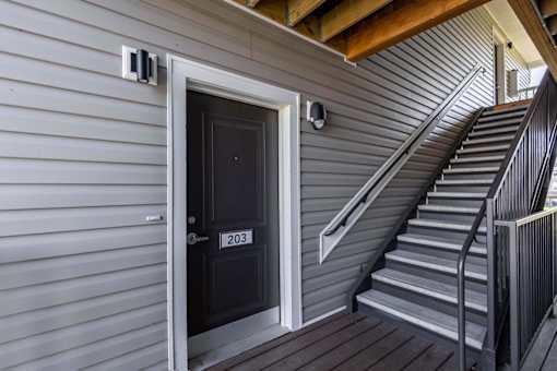 A black door with the number 203 on it.