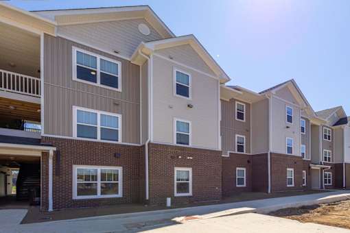 Apartment complex with multiple buildings and balconies.