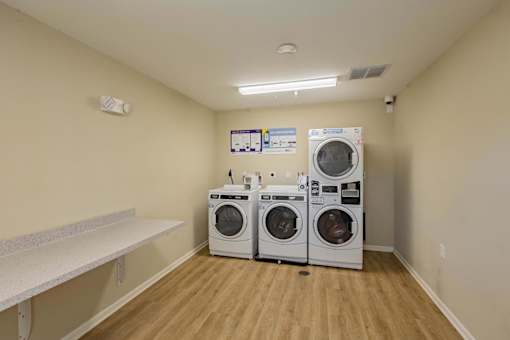 A laundry room with two front loading washing machines.