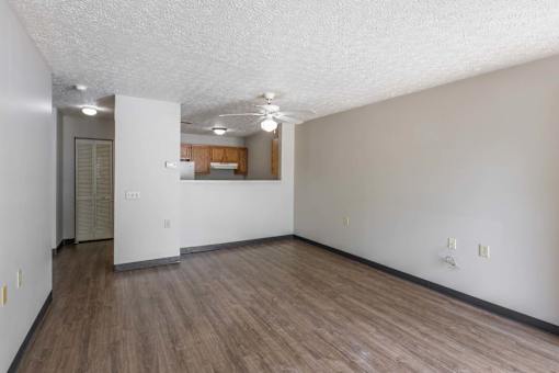 A room with a white ceiling and wooden flooring.