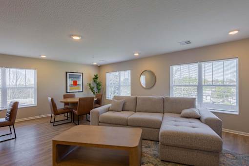 A living room with a couch, chairs, and a coffee table.