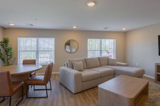 A living room with a couch, chairs, and a coffee table.