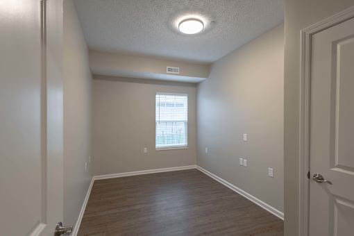 A room with a window and a door.
