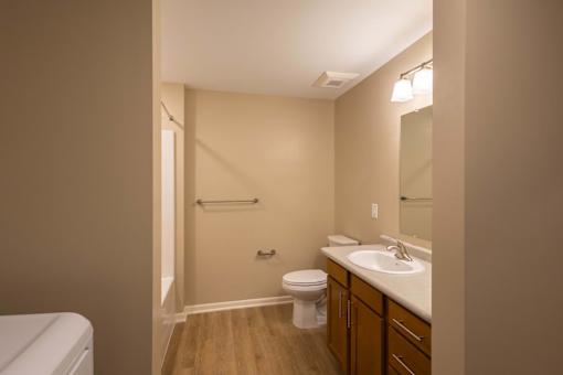 A bathroom with a toilet, sink, and shower.