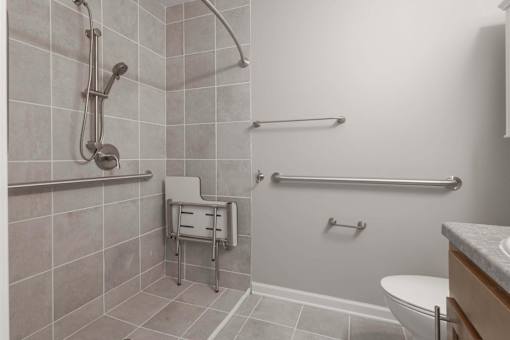 A bathroom with a toilet, sink, and shower.