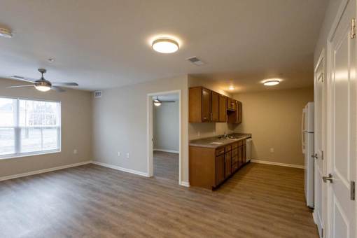 A kitchen with wooden cabinets and a ceiling fan.