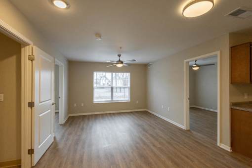 A room with a ceiling fan and a window.