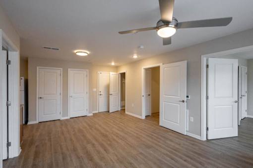 A room with a ceiling fan and lighting fixtures.