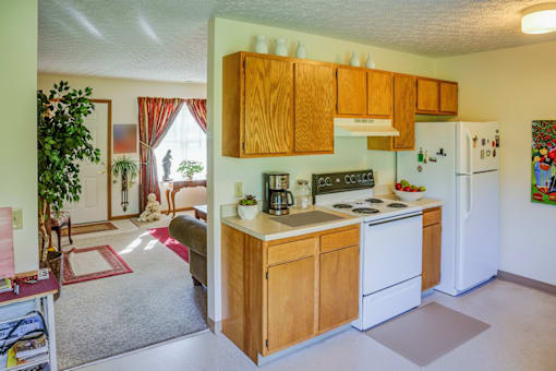 A kitchen with wooden cabinets and a white refrigerator.