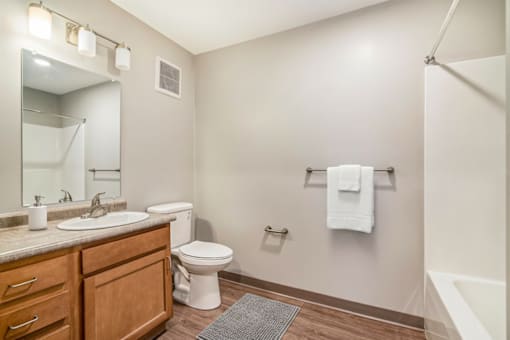 A white toilet sits next to a sink in a bathroom.