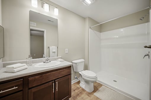 A bathroom with a white toilet, sink, and bathtub.