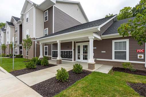 A two story building with a front porch and a sign that says FDC.