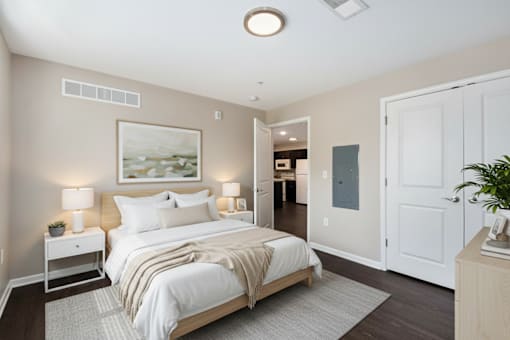 A bedroom with a large bed and a painting on the wall.