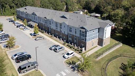 A large building with a parking lot in front of it.