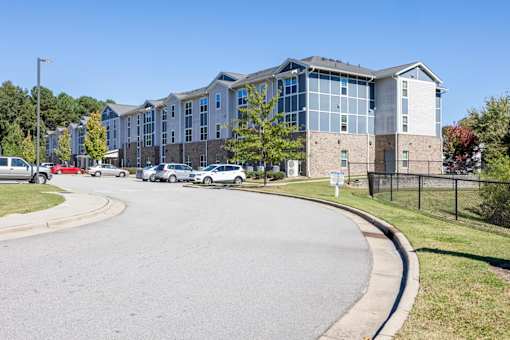 A large building with a parking lot in front of it.