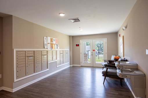 A room with a row of mailboxes on the wall.