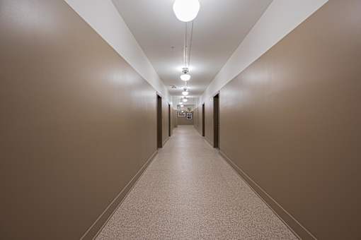 A long hallway with lights on the ceiling.