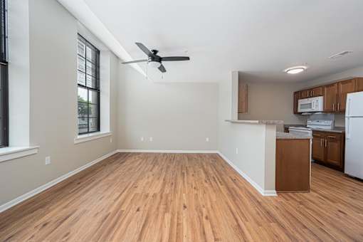 A room with wooden floors and a ceiling fan.