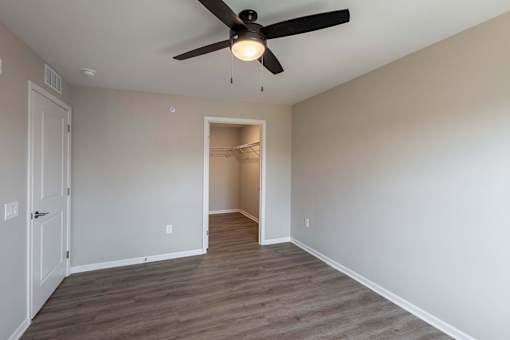 A room with a ceiling fan and light fixture.