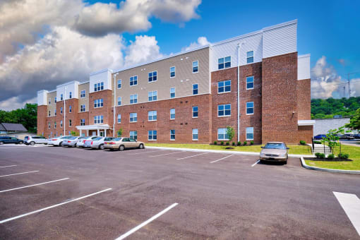 a large brick building with a parking lot in front of it