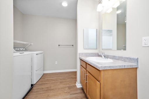 a bathroom with a sink and a washer and dryer
