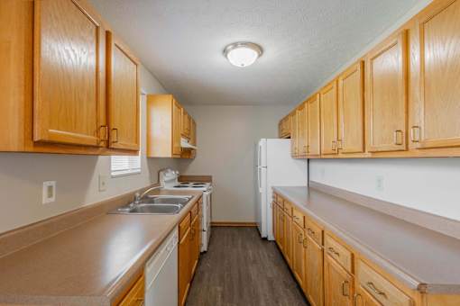 A kitchen with wooden cabinets and a white refrigerator.