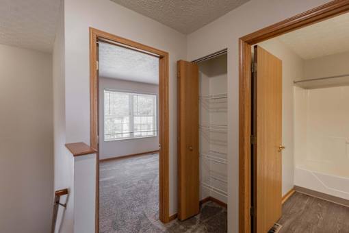 A room with a wooden door and a window.
