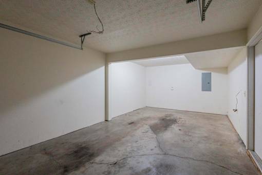 A room with a concrete floor and white walls.