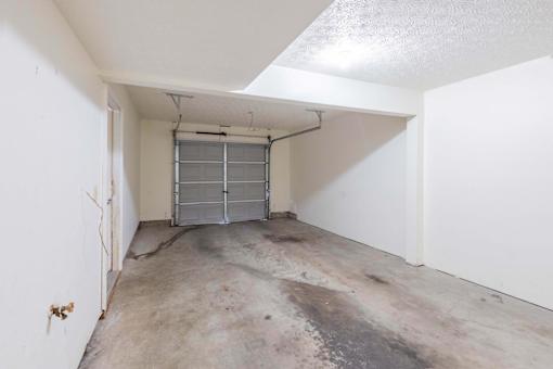 A white room with a metal gate in the middle.