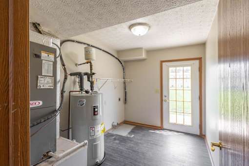 A room with a furnace and air conditioner unit.