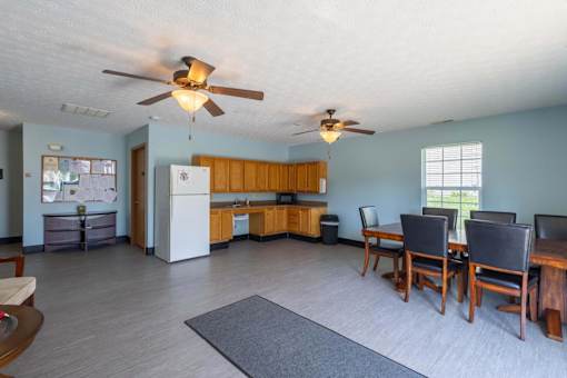 A living room with a dining table and chairs.