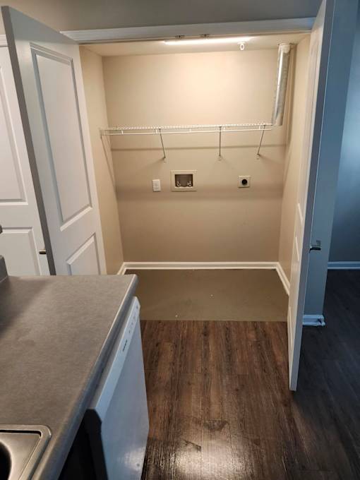 A small laundry room with a washer and dryer.
