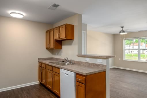 a kitchen with brown cabinets and a white dishwasher