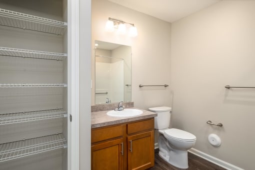 a bathroom with a toilet sink and mirror