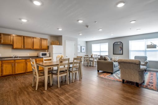a living room with a wooden table and chairs