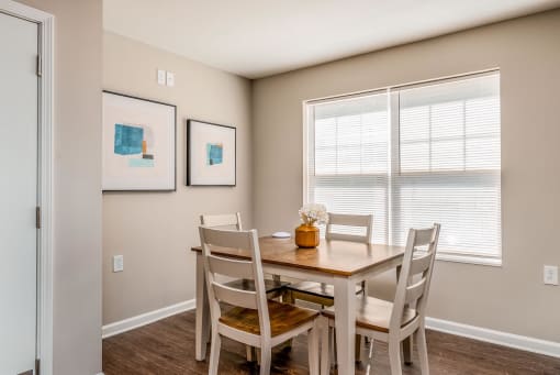 a dining room with a table and chairs