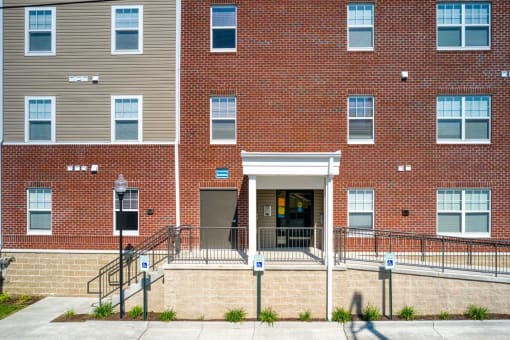 a large brick building with a staircase in front of it